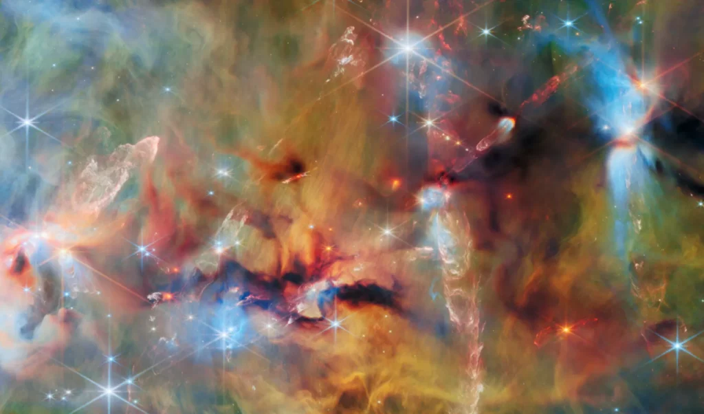 El Telescopio James Webb Descubre una Espectacular Fábrica de Estrellas Oculta Tras la Nebulosa de Orión